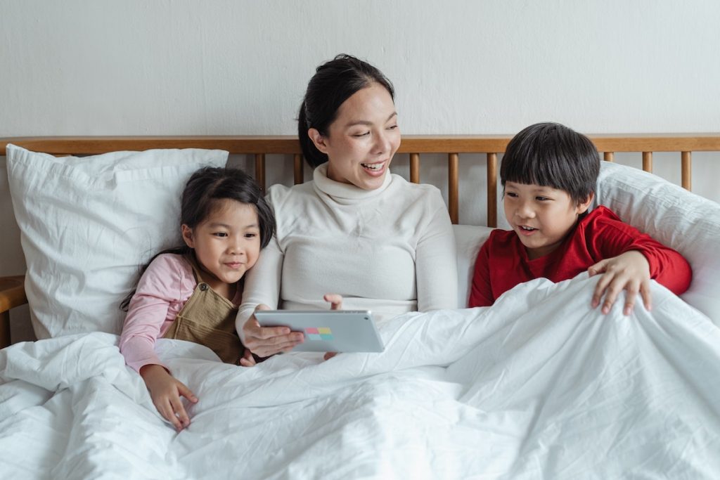 family under blanket enjoying air conditioning