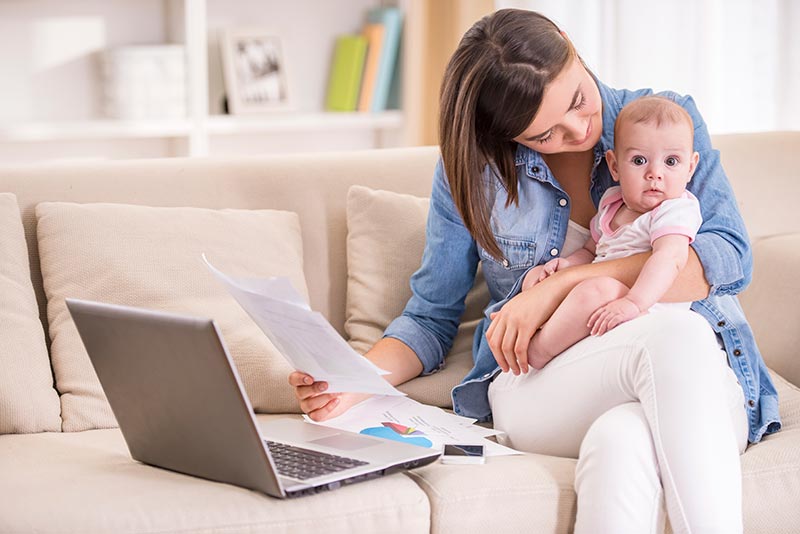 Mother working from home with baby on her lap