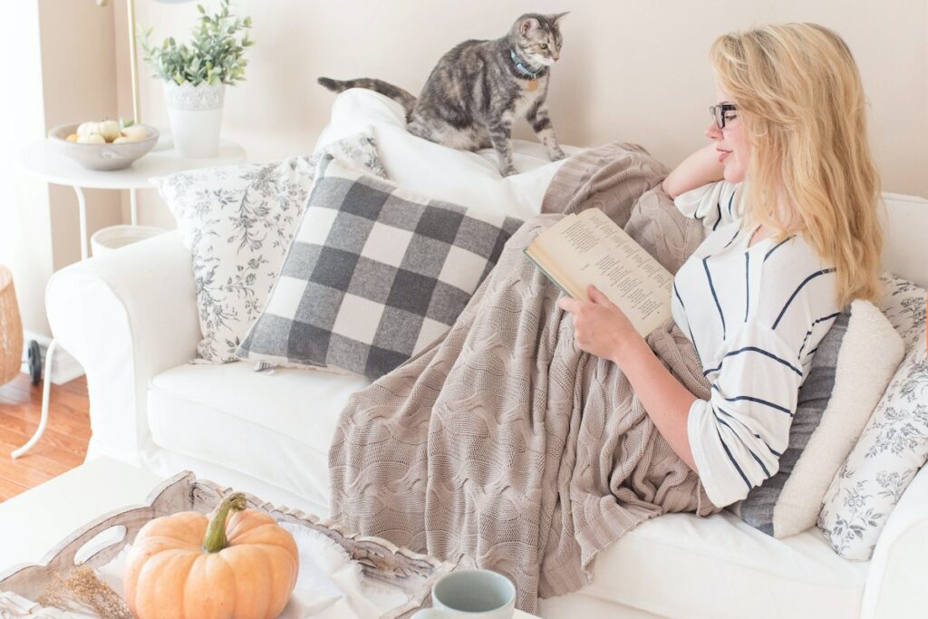 woman reading on cozy couch